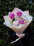 Load image into Gallery viewer, Person holding a bouquet of 6 faux, real-touch roses in shades of pink. 
