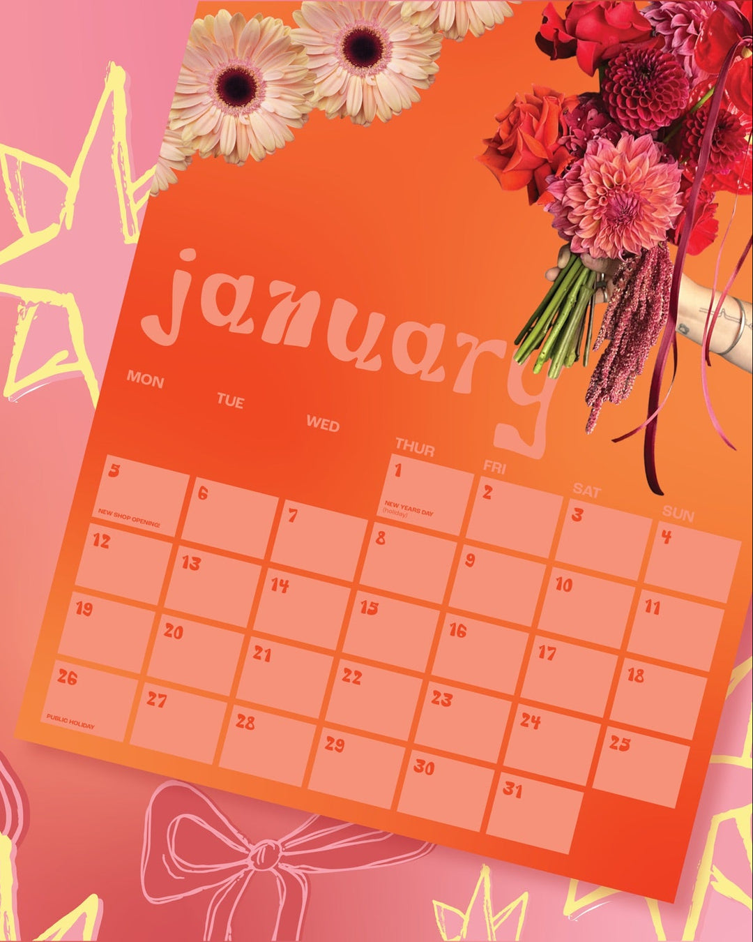 Promotional image for 2026 calendars with a calendar page and floral arrangements on a pink background.