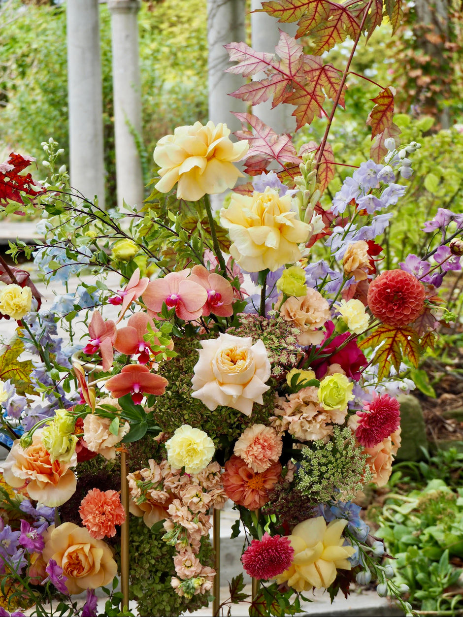 Colorful flower arrangement with a garden background