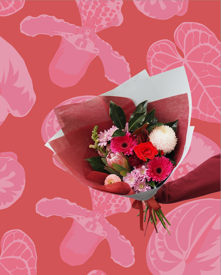 Bouquet of flowers on a pink floral patterned background